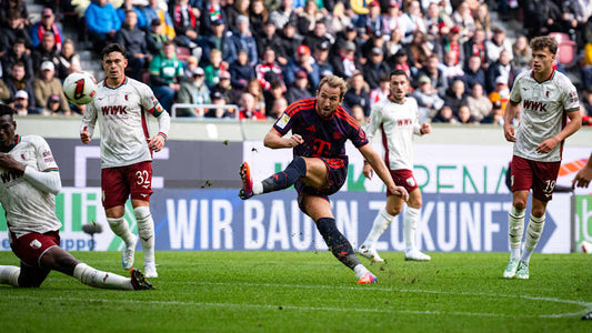 Harry Kane strikes the ball during Bayern’s away match at Augsburg.
